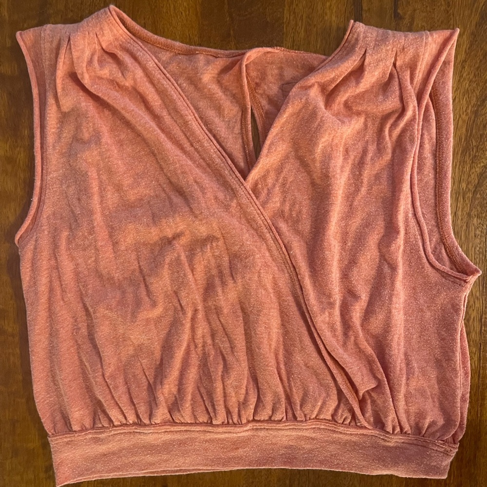 Pale orange shirt with open back detail. Size small